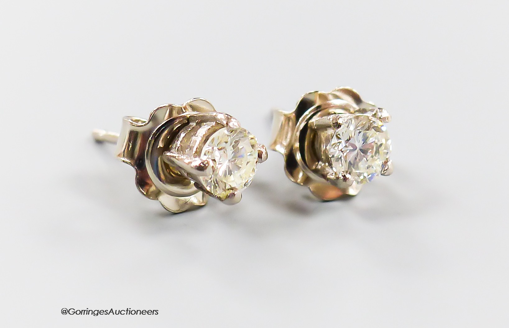 A modern pair of 750 white metal and solitaire diamond ear studs, each stone weighing approximately 0.23ct, gross weight 1.3 grams.